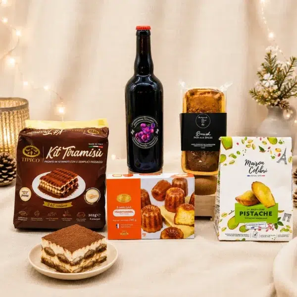 Cadeau gourmand composé d'un kit tiramisu italien, d'un jus de raisin pétillant BIO sans alcool, de canelés traditionnels, de madeleines à la pistache et d'un pain d'épices artisanal.